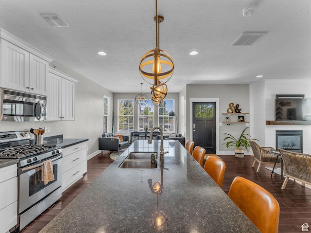 4966 W Willamette Way S, South Jordan, UT 84095 - kitchen featuring stainless steel appliances, white cabinets, recessed lighting, a textured ceiling, and dark wood finished floors