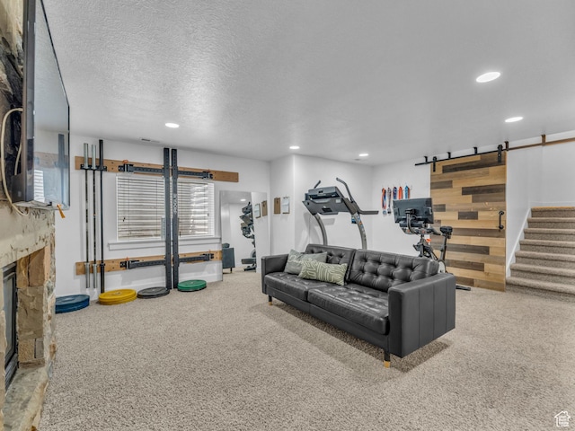 4966 W Willamette Way S, South Jordan, UT 84095 - living room with a barn door, recessed lighting, carpet, a fireplace, and a textured ceiling