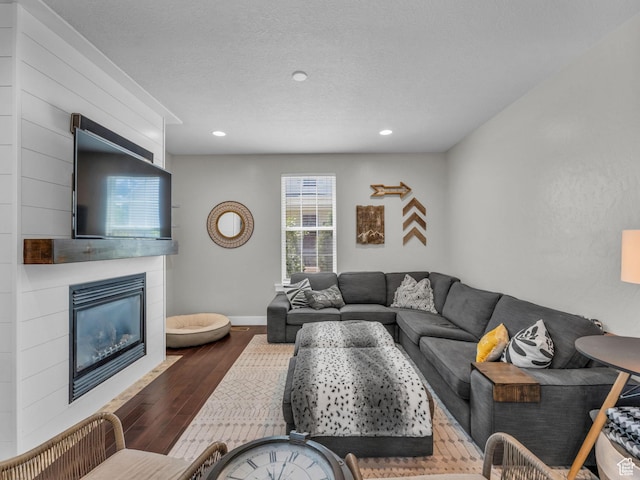 4966 W Willamette Way S, South Jordan, UT 84095 - living room with wood finished floors, a tiled fireplace, and recessed lighting