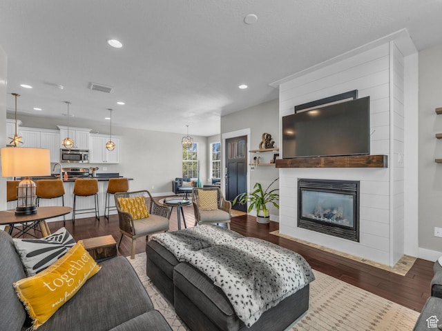 4966 W Willamette Way S, South Jordan, UT 84095 - living area featuring wood finished floors, a large fireplace, and recessed lighting
