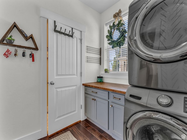 4966 W Willamette Way S, South Jordan, UT 84095 - laundry room with estacked washer and dryer, cabinet space, and dark wood-style flooring