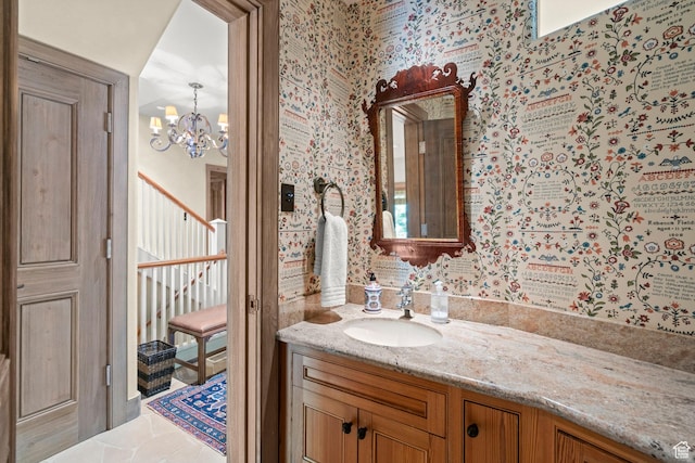 6033 S 2300 E, Holladay, UT 84121 - bathroom featuring wallpapered walls, a chandelier, and vanity