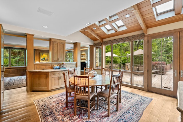 6033 S 2300 E, Holladay, UT 84121 - dining space featuring a skylight, plenty of natural light, light wood-style flooring, a fireplace, and recessed lighting
