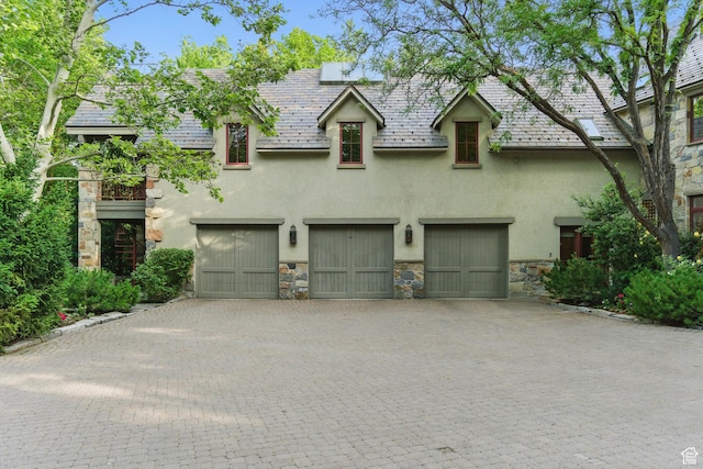 6033 S 2300 E, Holladay, UT 84121 - view of front of property with stone siding, stucco siding, an attached garage, decorative driveway, and a high end roof