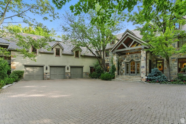 6033 S 2300 E, Holladay, UT 84121 - view of front facade with stone siding, stucco siding, driveway, and french doors