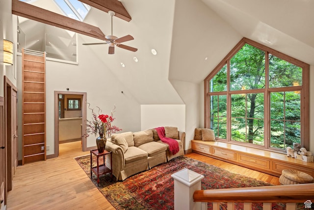 6033 S 2300 E, Holladay, UT 84121 - living area with wood finished floors, ceiling fan, high vaulted ceiling, a skylight, and beam ceiling