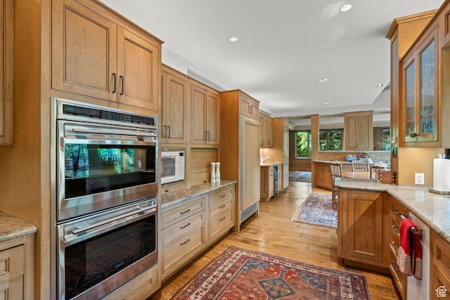 6033 S 2300 E, Holladay, UT 84121 - kitchen featuring stainless steel double oven, light wood-style flooring, light stone countertops, glass insert cabinets, and white microwave