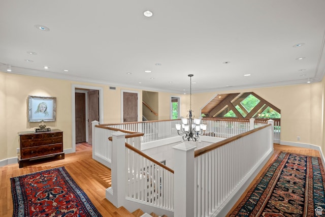 6033 S 2300 E, Holladay, UT 84121 - hallway featuring an upstairs landing, a chandelier, ornamental molding, light wood-style flooring, and plenty of natural light