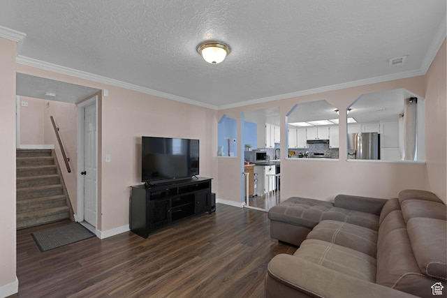 3684 W 4625 S, Roy, UT 84067 - living area featuring dark wood-type flooring, crown molding, a textured ceiling, and stairs