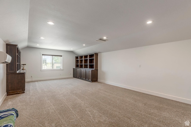 9532 S Willow Trail Way S, Jordan, UT 84095 - unfurnished living room featuring vaulted ceiling, light carpet, recessed lighting, and a wall unit AC