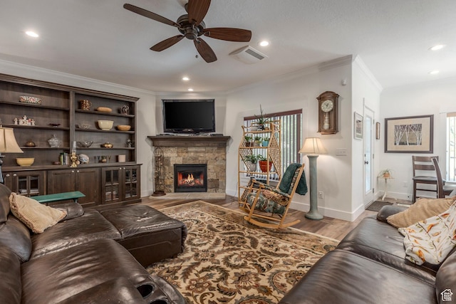 9532 S Willow Trail Way S, Jordan, UT 84095 - living area with ornamental molding, a ceiling fan, a stone fireplace, wood finished floors, and recessed lighting