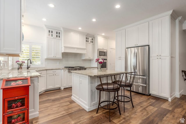 9532 S Willow Trail Way S, Jordan, UT 84095 - kitchen featuring appliances with stainless steel finishes, white cabinets, backsplash, recessed lighting, and a kitchen island