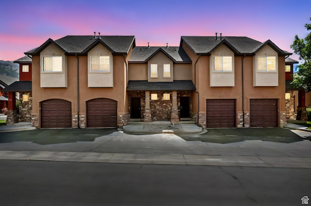283 S 840 W, Pleasant Grove, UT 84062 - townhome / multi-family property with a garage, stucco siding, stone siding, and driveway