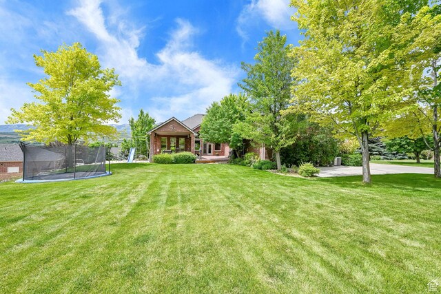 3990 Summer Ridge Rd, Morgan, UT 84050 - view of grassy yard with a trampoline