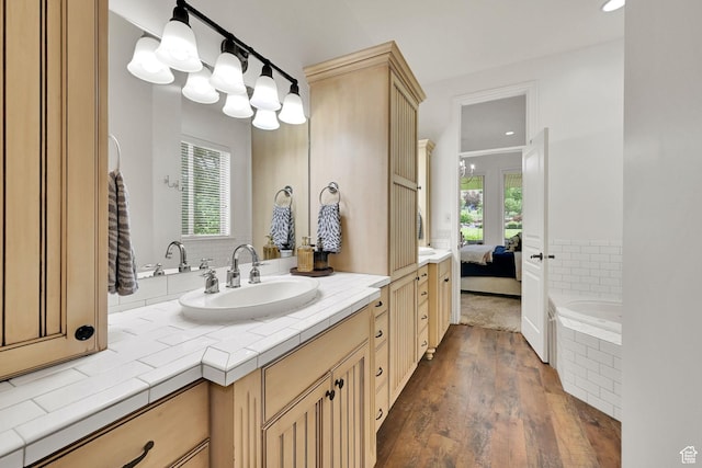 3990 Summer Ridge Rd, Morgan, UT 84050 - bathroom featuring wood finished floors, vanity, connected bathroom, a relaxing tiled tub, and recessed lighting