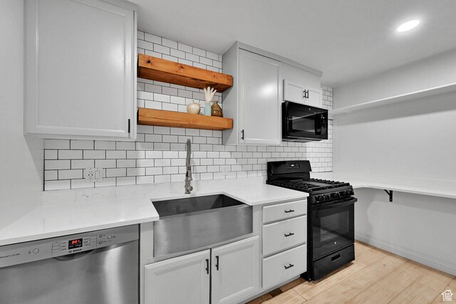 3990 Summer Ridge Rd, Morgan, UT 84050 - kitchen with black appliances, open shelves, decorative backsplash, light wood-style floors, and light countertops