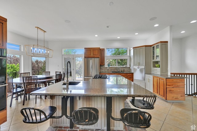 3990 Summer Ridge Rd, Morgan, UT 84050 - kitchen featuring freestanding refrigerator, a breakfast bar area, recessed lighting, light tile patterned floors, and a spacious island