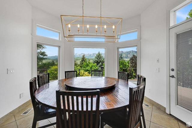 3990 Summer Ridge Rd, Morgan, UT 84050 - dining room with a towering ceiling, plenty of natural light, light tile patterned floors, and a chandelier