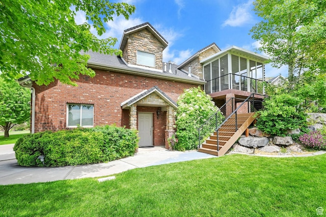 3990 Summer Ridge Rd, Morgan, UT 84050 - view of front of home featuring a sunroom, a front lawn, stairs, brick siding, and stone siding