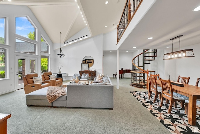3990 Summer Ridge Rd, Morgan, UT 84050 - carpeted living room featuring stairs, plenty of natural light, high vaulted ceiling, rail lighting, and recessed lighting