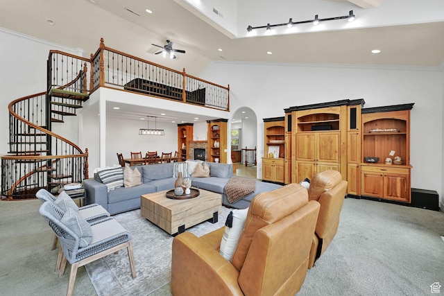 3990 Summer Ridge Rd, Morgan, UT 84050 - living room featuring arched walkways, light carpet, stairway, ceiling fan, and high vaulted ceiling