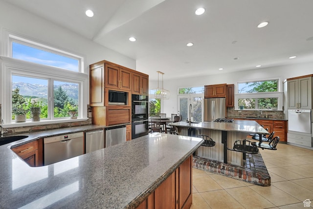 3990 Summer Ridge Rd, Morgan, UT 84050 - kitchen featuring stainless steel appliances, decorative backsplash, recessed lighting, dark stone countertops, and a kitchen bar