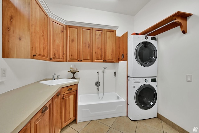 3990 Summer Ridge Rd, Morgan, UT 84050 - laundry room featuring stacked washer / drying machine, cabinet space, and light tile patterned floors
