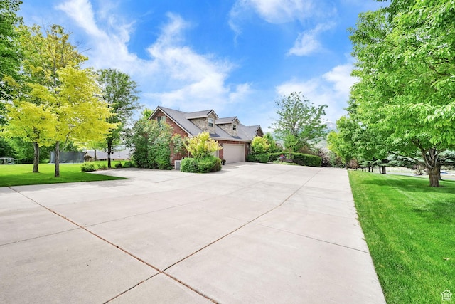 3990 Summer Ridge Rd, Morgan, UT 84050 - view of front of house with concrete driveway, a garage, a front yard, and brick siding