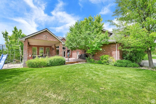3990 Summer Ridge Rd, Morgan, UT 84050 - rear view of property with brick siding, a lawn, and a wooden deck