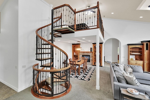 3990 Summer Ridge Rd, Morgan, UT 84050 - stairs with arched walkways, a high ceiling, a stone fireplace, carpet, and recessed lighting