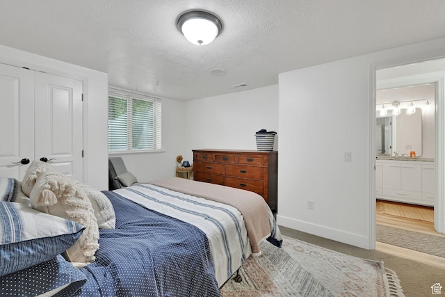 3990 Summer Ridge Rd, Morgan, UT 84050 - bedroom with a textured ceiling, light colored carpet, and ensuite bath