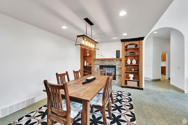 3990 Summer Ridge Rd, Morgan, UT 84050 - dining space with light carpet, recessed lighting, arched walkways, and a fireplace