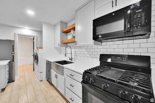 3990 Summer Ridge Rd, Morgan, UT 84050 - kitchen featuring separate washer and dryer, black appliances, light countertops, backsplash, and recessed lighting