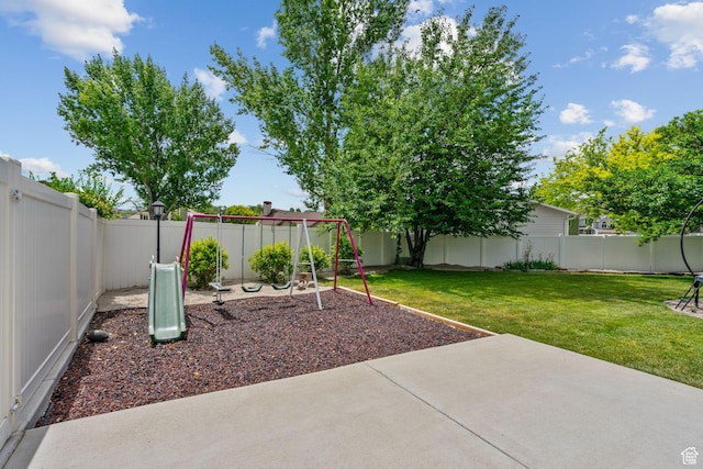 13082 S 2770th Cir W, Riverton, UT 84065 - fenced backyard with a playground and a patio area