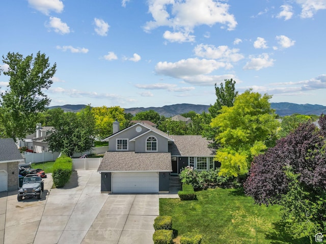 13082 S 2770th Cir W, Riverton, UT 84065 - view of front of property with a mountain view, a garage, concrete driveway, and roof with shingles