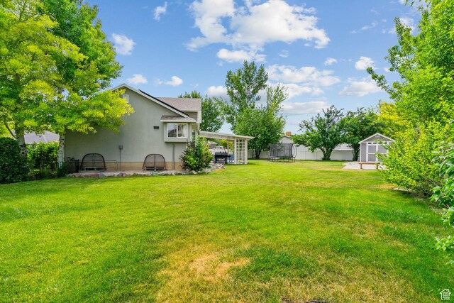 13082 S 2770th Cir W, Riverton, UT 84065 - view of yard with a trampoline