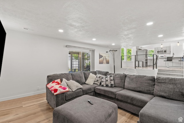 13082 S 2770th Cir W, Riverton, UT 84065 - living room featuring light wood-style floors and recessed lighting