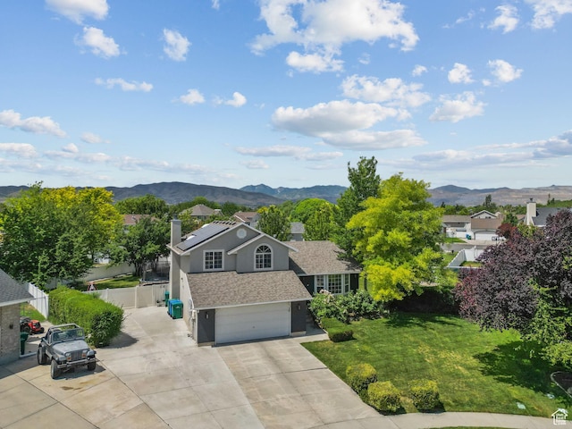 13082 S 2770th Cir W, Riverton, UT 84065 - view of front of house featuring a chimney, a mountain view, a garage, concrete driveway, and stucco siding