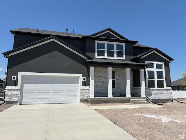 635 E 240 N Unit 9, Tremonton, UT 84337 - view of front of property featuring stone siding, a porch, stucco siding, and driveway