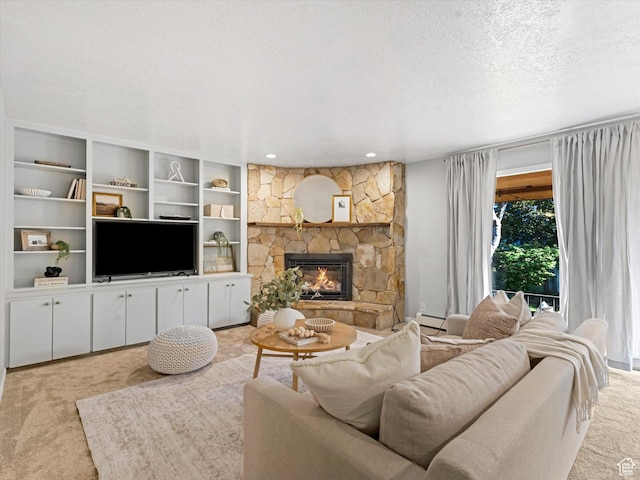 1411 E 1220 N, Logan, UT 84341 - living area with carpet floors, a baseboard radiator, a stone fireplace, a textured ceiling, and recessed lighting