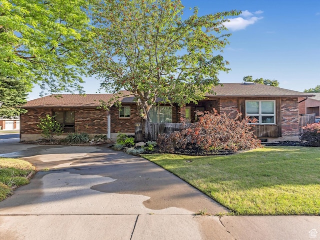1411 E 1220 N, Logan, UT 84341 - ranch-style home with brick siding and a front lawn
