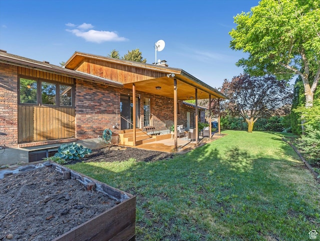 1411 E 1220 N, Logan, UT 84341 - rear view of property featuring a patio, a yard, and brick siding