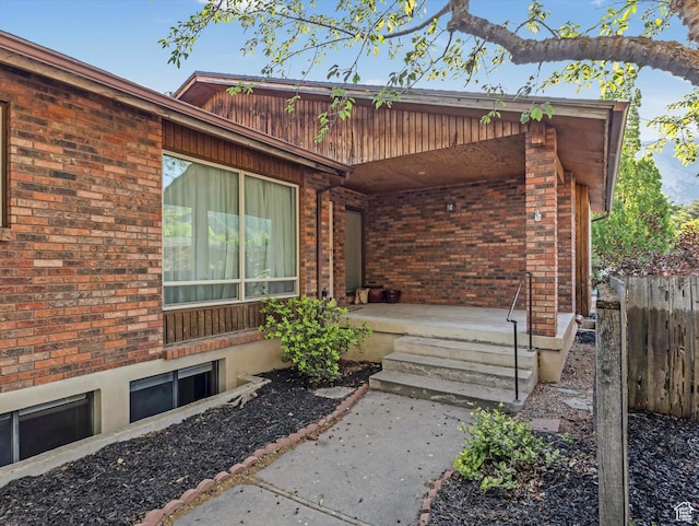 1411 E 1220 N, Logan, UT 84341 - property entrance featuring covered porch and brick siding