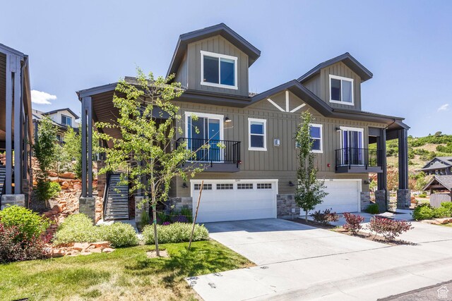 3249 Quarry Springs Dr, Park City, UT 84098 - view of front of house with board and batten siding, an attached garage, concrete driveway, and stone siding
