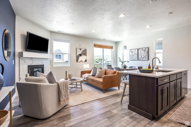3249 Quarry Springs Dr, Park City, UT 84098 - living area featuring light wood-style floors, a fireplace, a textured ceiling, and recessed lighting