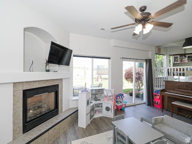 4242 W 11430 S, South Jordan, UT 84009 - living area featuring wood finished floors, ceiling fan, and a tiled fireplace