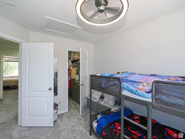 4242 W 11430 S, South Jordan, UT 84009 - bedroom featuring attic access, light colored carpet, ceiling fan, a walk in closet, and a closet