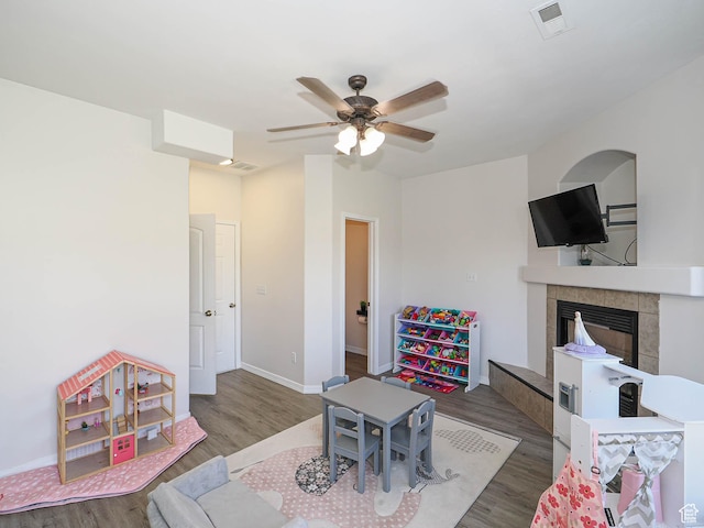 4242 W 11430 S, South Jordan, UT 84009 - living area with wood finished floors, a tiled fireplace, and a ceiling fan