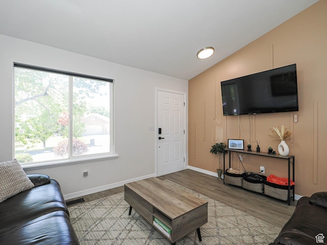 4242 W 11430 S, South Jordan, UT 84009 - living area featuring healthy amount of natural light, wood finished floors, and vaulted ceiling