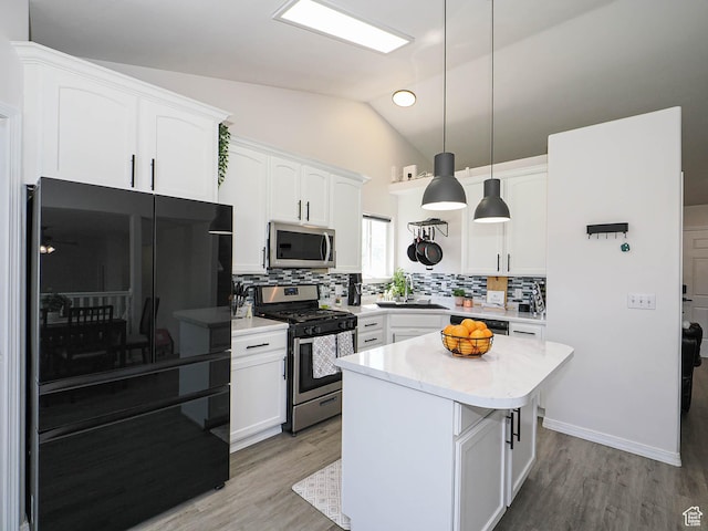 4242 W 11430 S, South Jordan, UT 84009 - kitchen featuring appliances with stainless steel finishes, lofted ceiling, backsplash, white cabinets, and light countertops